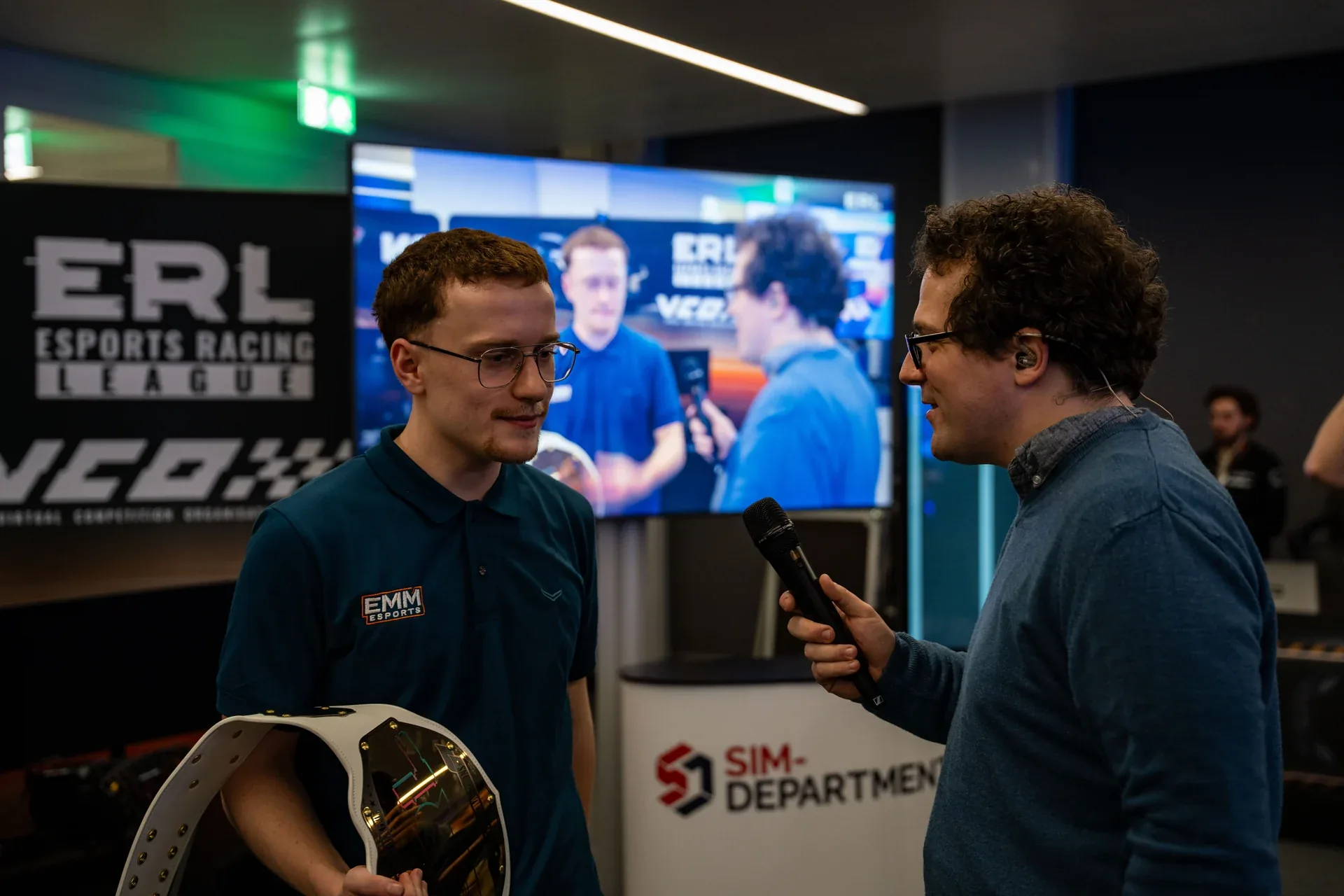 RAFA ERA ESPORTS team members speaking beside a trophy at the ERL Final Four at Sim Formula Europe.