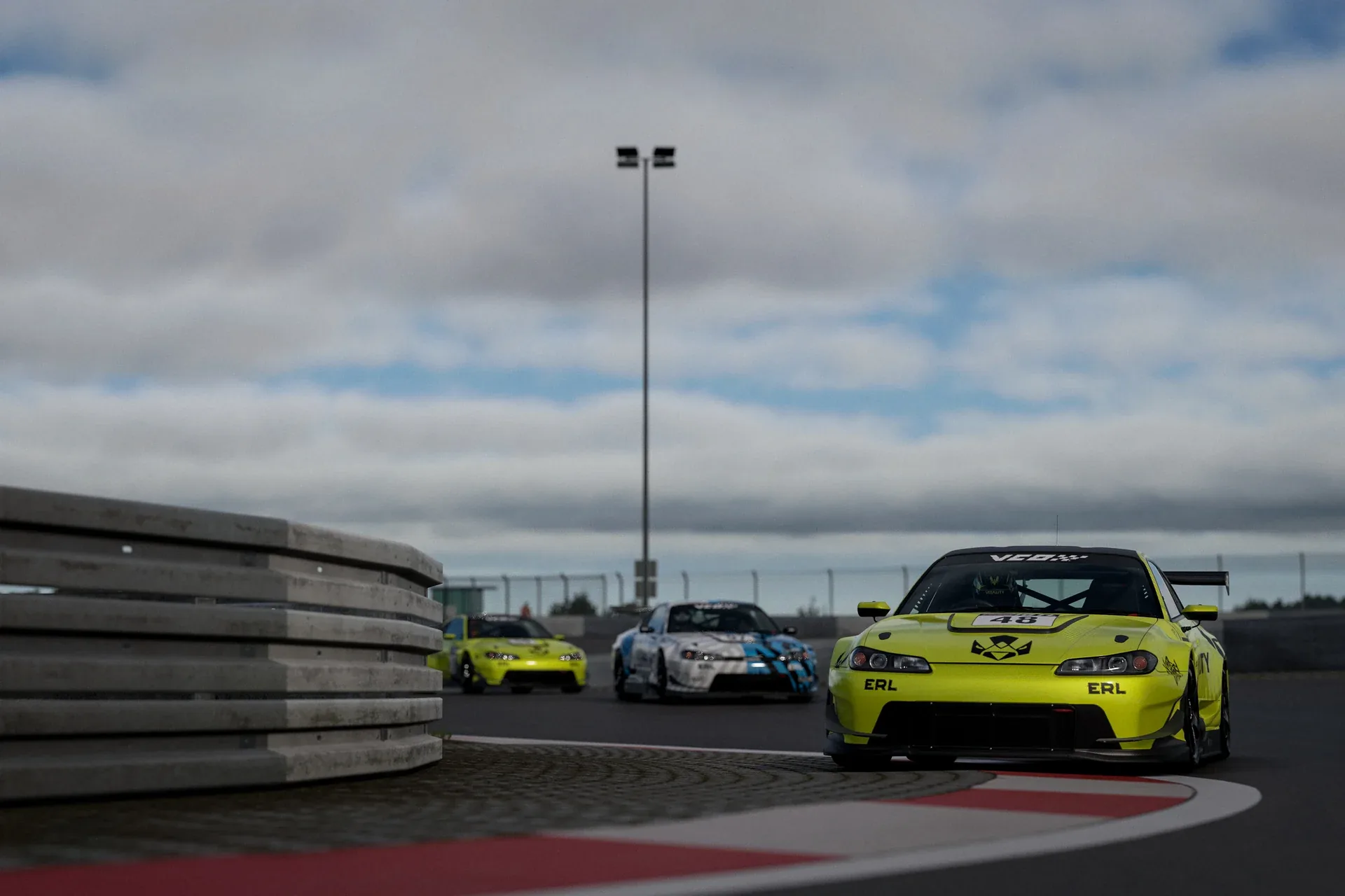 A yellow Vitality Simracing car leading through a corner in the 2026 ERL Gran Turismo 7 round.